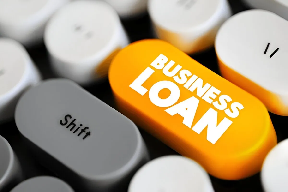How to Get a Commercial Loan With No Money Down Business owner reviewing commercial loan documents with a banker